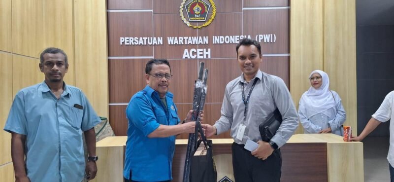 Plt Kabid Humas Bank Aceh Syariah, Hafas menyerahkan cinderamata kepada Ketua PWI Aceh seusai silaturahmi dan diskusi dengan Pengurus PWI Aceh di Kantor PWI Aceh, kawasan Simpang Lima, Banda Aceh, Rabu sore, 11 Juni 2025. Foto. Dok. Abdul Hadi