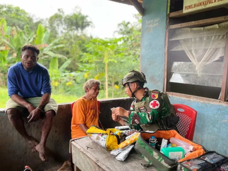 Prajurit Pos Kotis Satgas Yonif 512/QY melaksanakan kunjungan ke rumah tokoh masyarakat Distrik Waris, Bapa Natalius, sembari membawa perlengkapan medis untuk membuka layanan kesehatan gratis bagi warga sekitar. dok. Puspen TNI