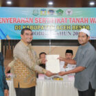 Kepala Kantor Kementerian Agama Aceh Besar H. Saifuddin S.E (kedua kiri) saat menyerahkan sertifikat tanah wakaf kepada salah satu nazir di Kantor Kejaksaan Negeri Aceh Besar, Jantho, Rabu (20/8/2025). (Foto: Humas Kemenag Aceh Besar)