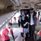 Wali Kota Banda Aceh Illiza Sa’aduddin Djamal bersama Gubernur Aceh Muzakir Manaf menyapa para pemudik di dalam bus sebelum keberangkatan program Mudik Gratis Pemerintah Aceh tahun 2026 di Terminal Batoh, Minggu (15/3/2026). Foto: Dok. Prokopim Kota Banda Aceh