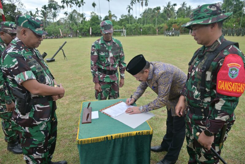 Bupati Pidie H. Sarjani Abdullah bersama Dansatgas TMMD ke-129 Kodim 0102/Pidie Letkol Inf Abdul Hadi menandatangani naskah serah terima hasil pelaksanaan TMMD ke-129 di Lapangan Bola Desa Lhok Panah, Kecamatan Sakti, Kamis (13/8/2026). Foto: Dok. Istimewa 