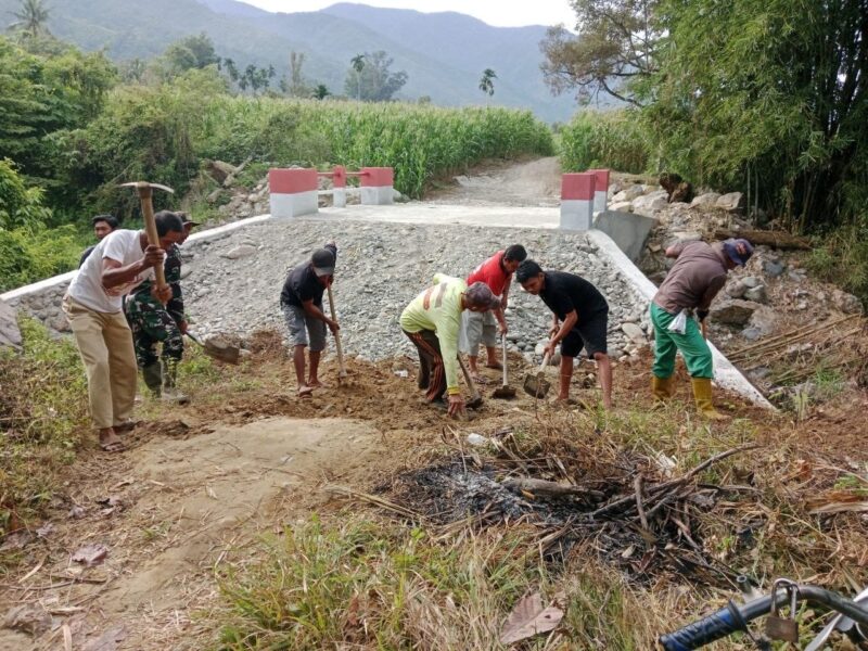 Babinsa Posramil Deleng Pokhkisen, Serda Arpit Journalis, bersama masyarakat bergotong royong menimbun bagian kiri dan kanan Jembatan Beton di Desa Bunga Melut, Kecamatan Deleng Pokhkisen, Aceh Tenggara, Sabtu (8/8/2026). Foto: Dok. Istimewa 