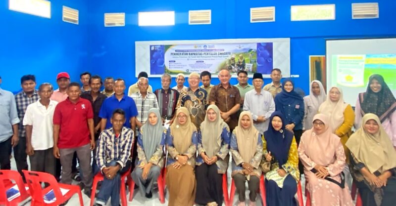 Camat Blang Bintang Subhan, S.E., M.M. bersama tim pengabdi USK dan peserta foto bersama usai mengikuti pelatihan uji tanah serta pemupukan presisi padi sawah dalam program PKMBP-TTG di Aula Kantor Camat Blang Bintang, Aceh Besar, Kamis (6/8/2026). Foto: Dok. Istimewa 