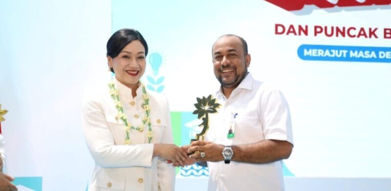 Direktur Utama Bank Aceh Syariah Fadhil Ilyas menerima KEJAR Award OJK Pusat 2026 dari Ketua Dewan Komisioner OJK Friderica Widyasari Dewi dalam rangkaian Puncak Hari Indonesia Menabung dan Bulan Literasi Keuangan 2026 di Sekolah Rakyat 13 Bekasi, Jumat (28/8/2026). Foto: Dok. Ist