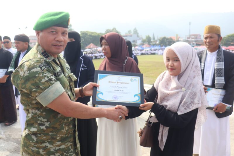 Pasi Pers Kodim 0106/Aceh Tengah Kapten Inf Ridwan menyerahkan piagam penghargaan kepada santriwati berprestasi pada upacara peringatan Hari Santri Nasional, Kamis (22/10/2026).dok:Ist